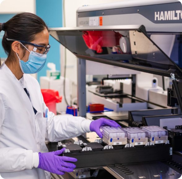 asian female scientist putting blood in Hamilton machine